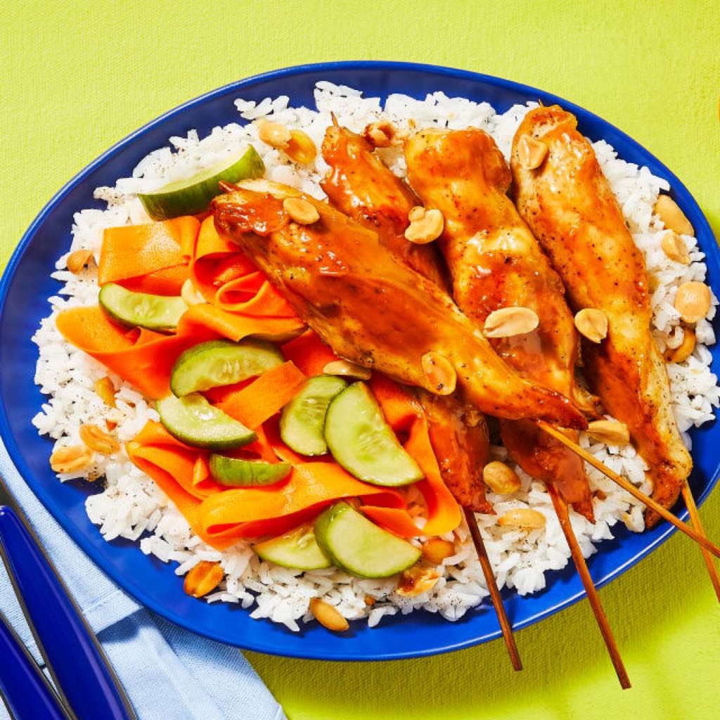 An image of Spicy Chicken Satay Skewers with Pickled Cucumber-Carrot Salad & Garlic Peanut Rice